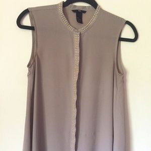Sleeveless button down blouse with studded detail